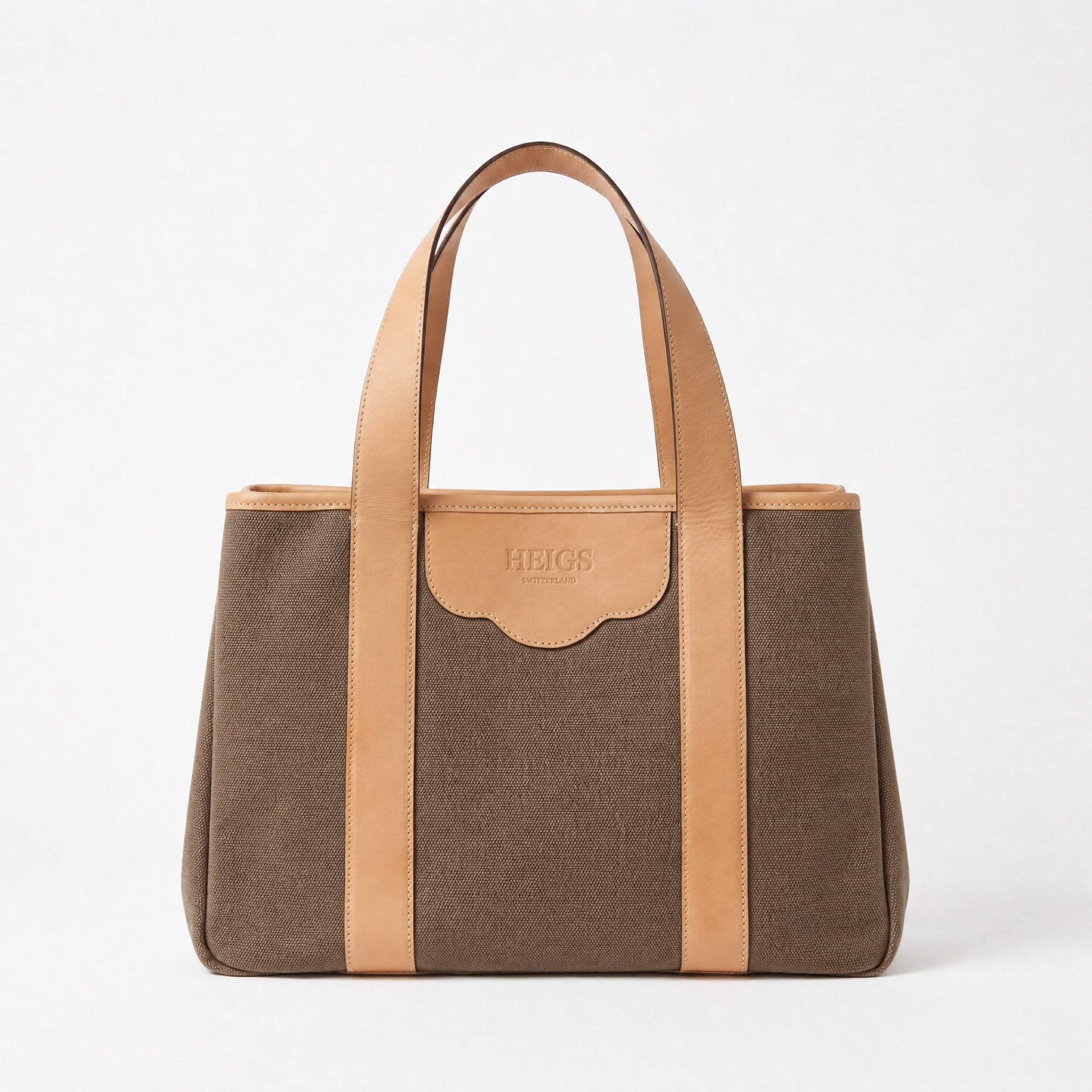 The à New York Tote Bag in Saddle Brown — saddle brown cotton canvas with undyed calfskin handles, HEIGS Switzerland