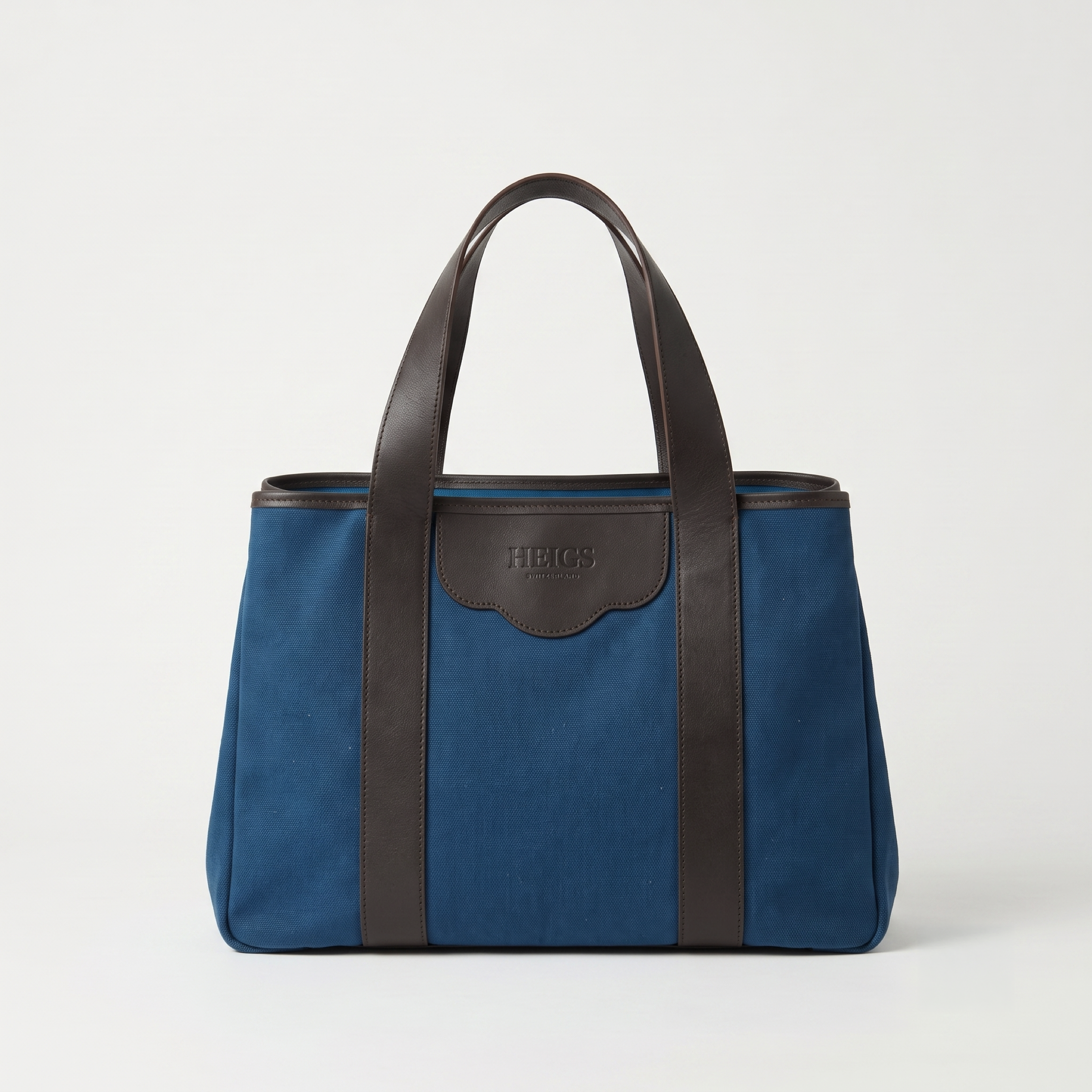 The à New York Tote Bag in Indigo — deep indigo cotton canvas with dark calfskin handles, HEIGS Switzerland